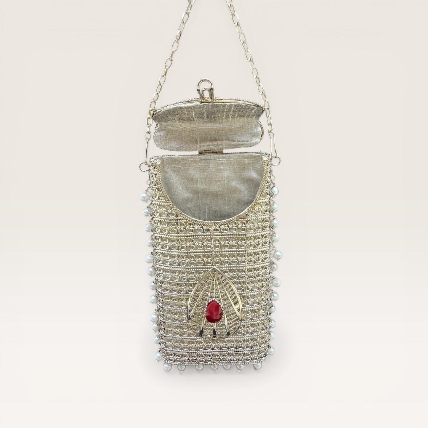 Designer brass phone clutch with pearl hangings and drop shaped stone detailing, ethnic party wear handbag
Premium Silver metal mobile bag with pearls and coloured stone accents, bridal clutch for women