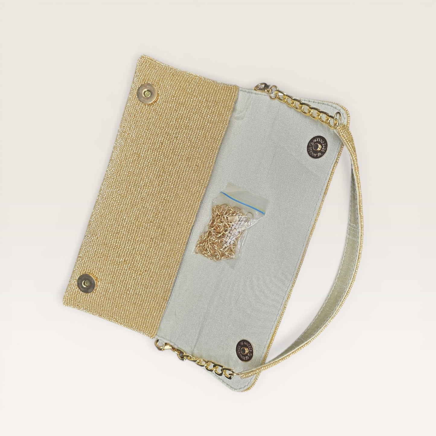Hand-embroidered pastel bead envelope clutch with gold chain and Kardana work.
