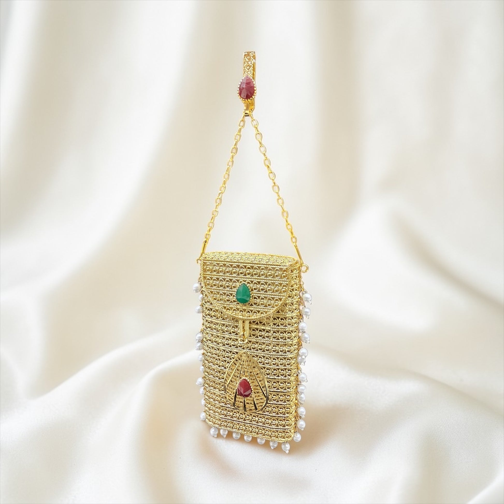 Designer brass phone clutch with pearl hangings and drop shaped stone detailing, ethnic party wear handbag
Premium gold metal mobile bag with pearls and coloured stone accents, bridal clutch for women