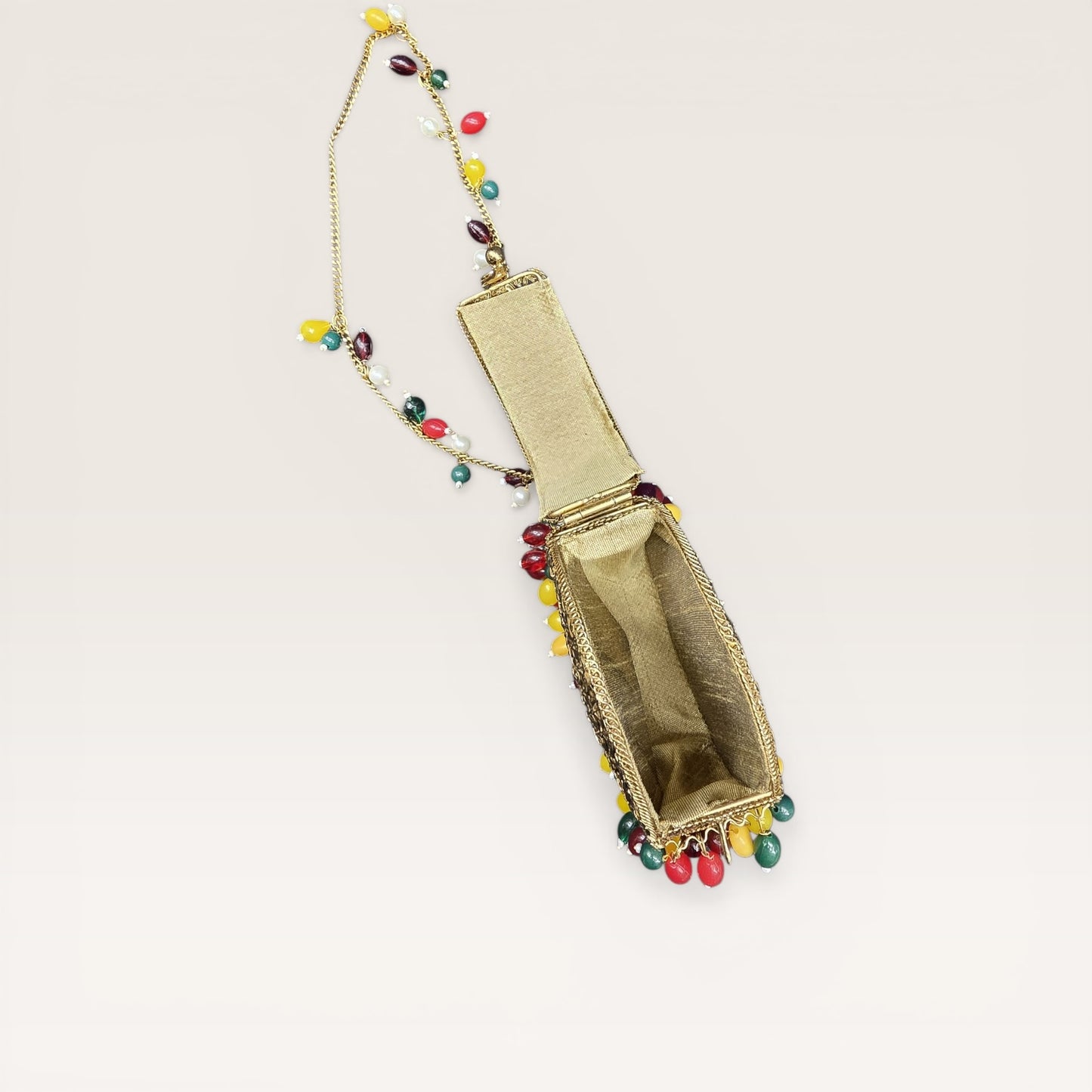 Unique drop silhouette brass handbag with vibrant bead fringe and gold-tone chain strap.