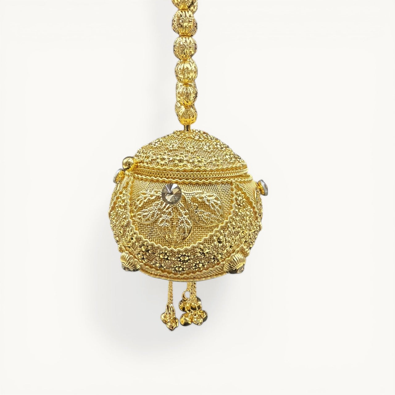 Handcrafted coconut-shaped brass mini clutch with gold filigree and beaded wristlet handle.