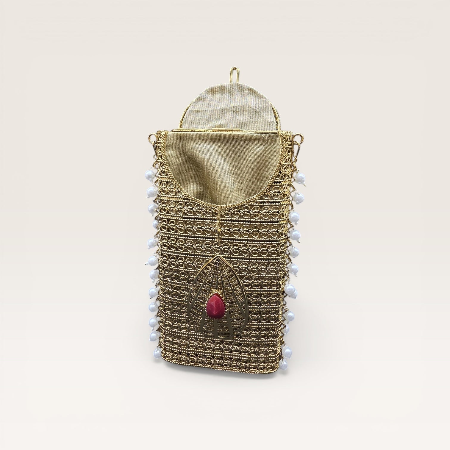 Ethnic brass mobile bag with pearl border detailing and gemstone accents, designer party clutch
Statement gold metal clutch with pearl hangings and teardrop stone motif, festive occasion bag