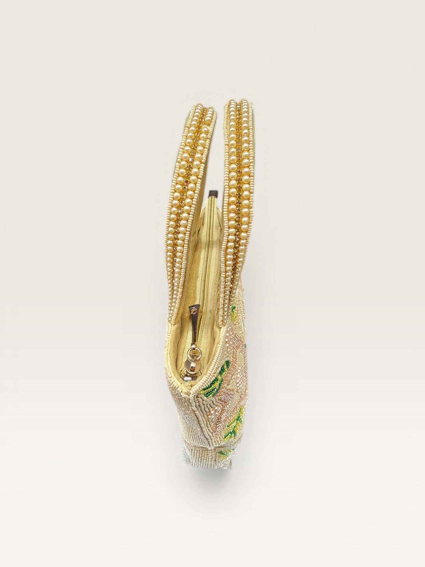 Hand-embroidered bucket bag with colorful floral beadwork and twin handles on a velvet base.