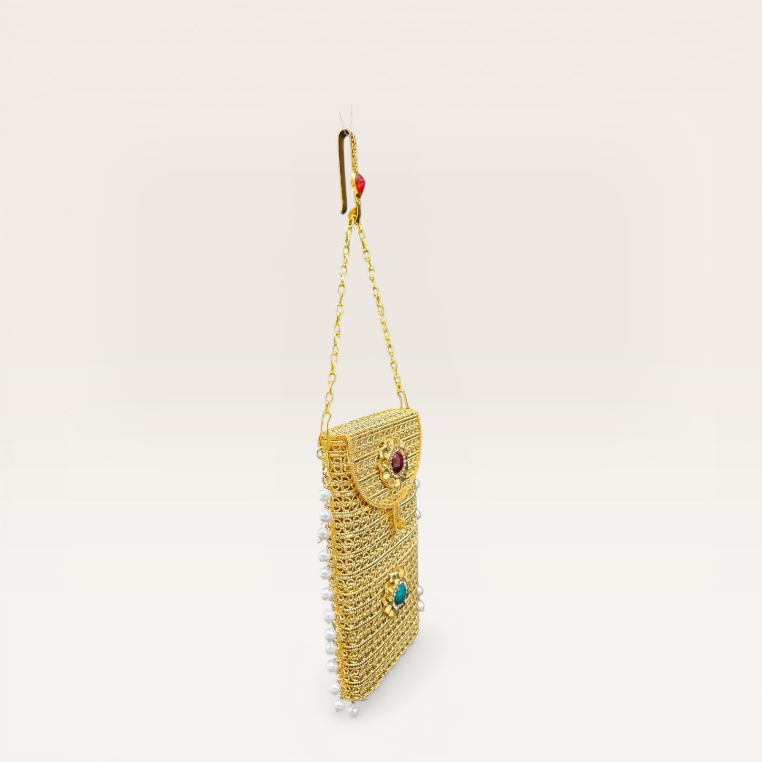 Handcrafted brass mobile clutch with pearl drops and colored stones for weddings and parties
Ethnic gold metal mobile purse with detachable chain and pearl border design
Trending gold brass clutch bag with gemstone detailing and pearl hangings for women