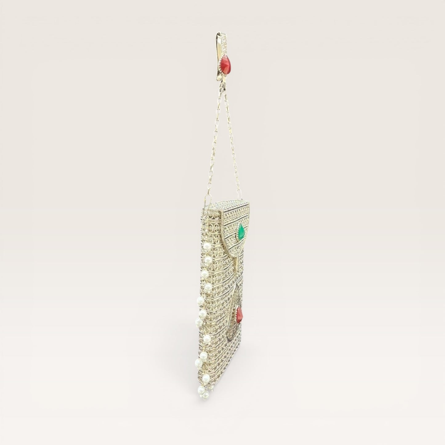 Handcrafted brass clutch with pearl fringes and teardrop stone design, festive mobile pouch bag
Luxury brass mobile clutch with intricate detailing, pearl hangings and coloured stone embellishment