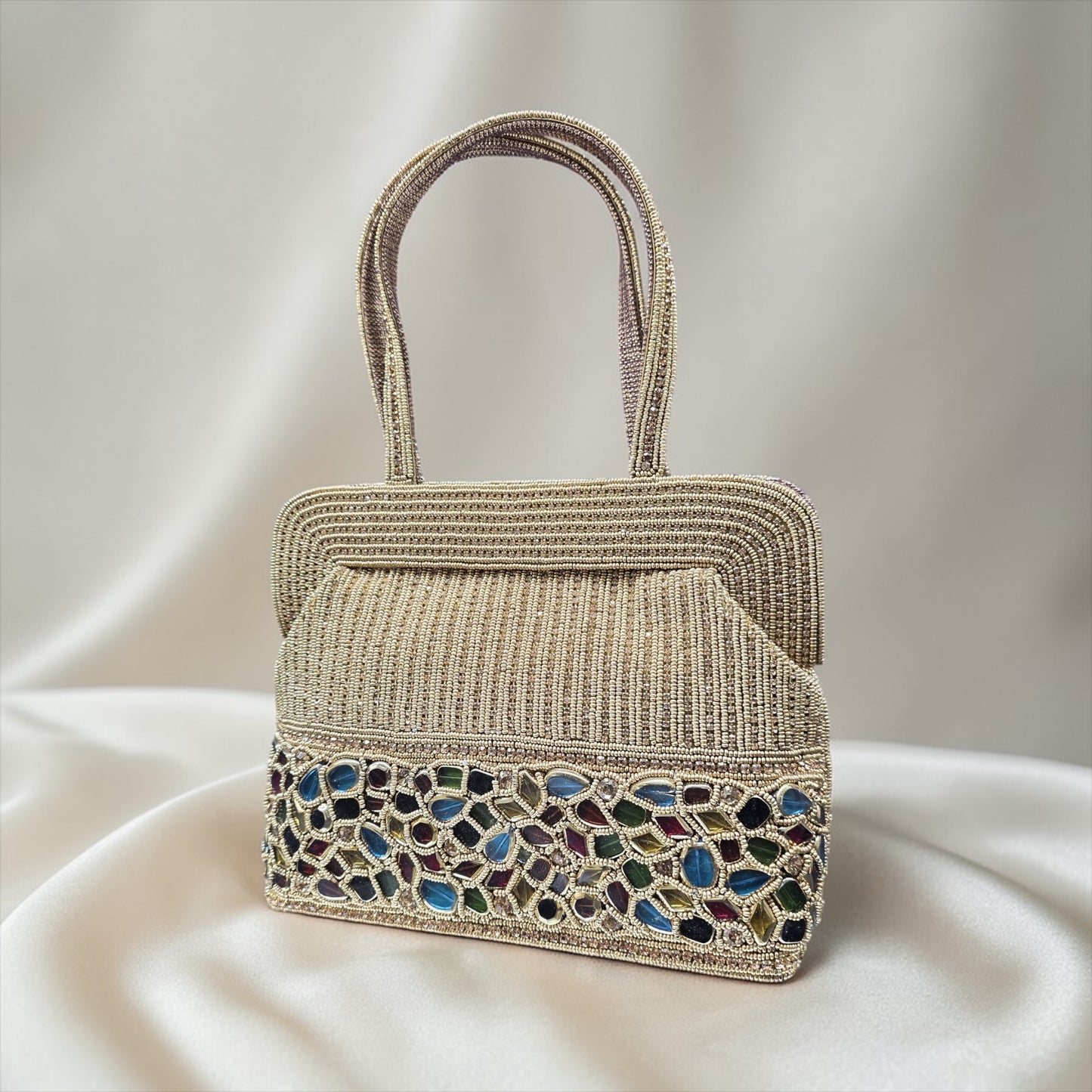 Hand-embroidered seed bead handbag with colorful stone border and twin embroidered handles.