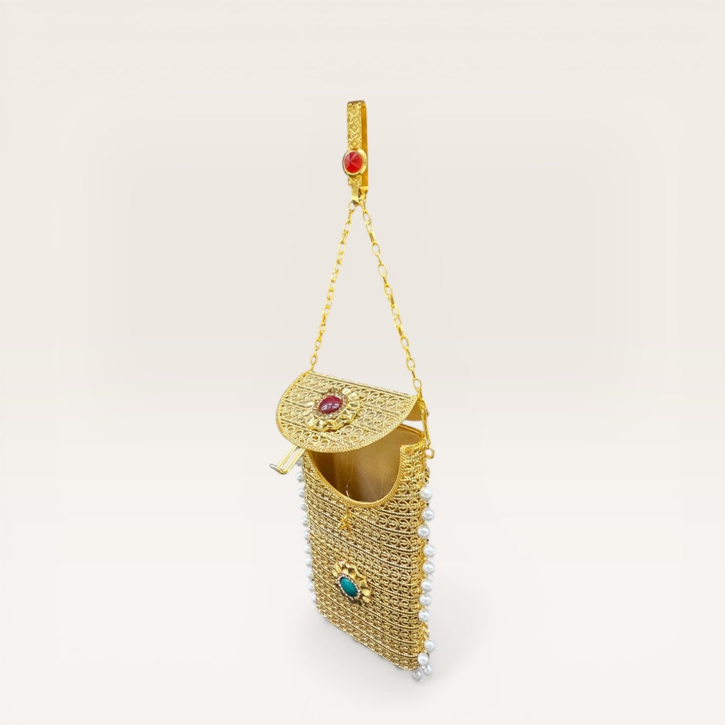 Handcrafted brass mobile clutch with pearl drops and colored stones for weddings and parties
Ethnic gold metal mobile purse with detachable chain and pearl border design
Trending gold brass clutch bag with gemstone detailing and pearl hangings for women