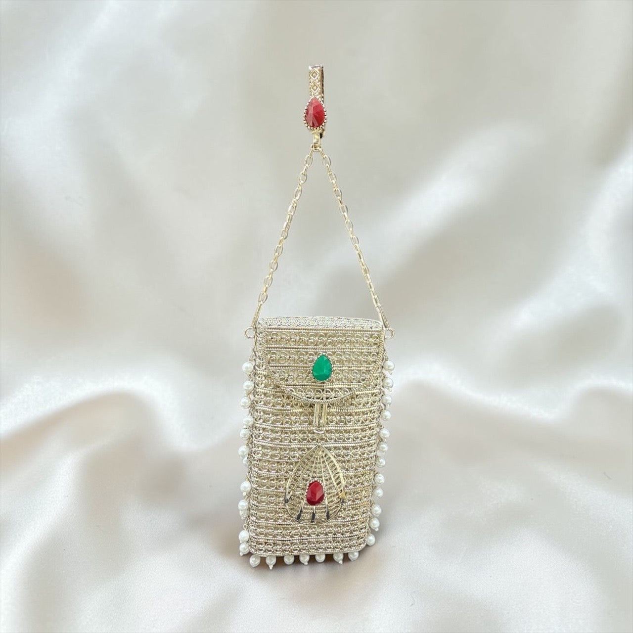 Silver brass mobile clutch with coloured teardrop stone and pearl tassels, luxury wedding phone bag
Designer brass phone clutch with pearl hangings and drop shaped stone detailing, ethnic party wear h