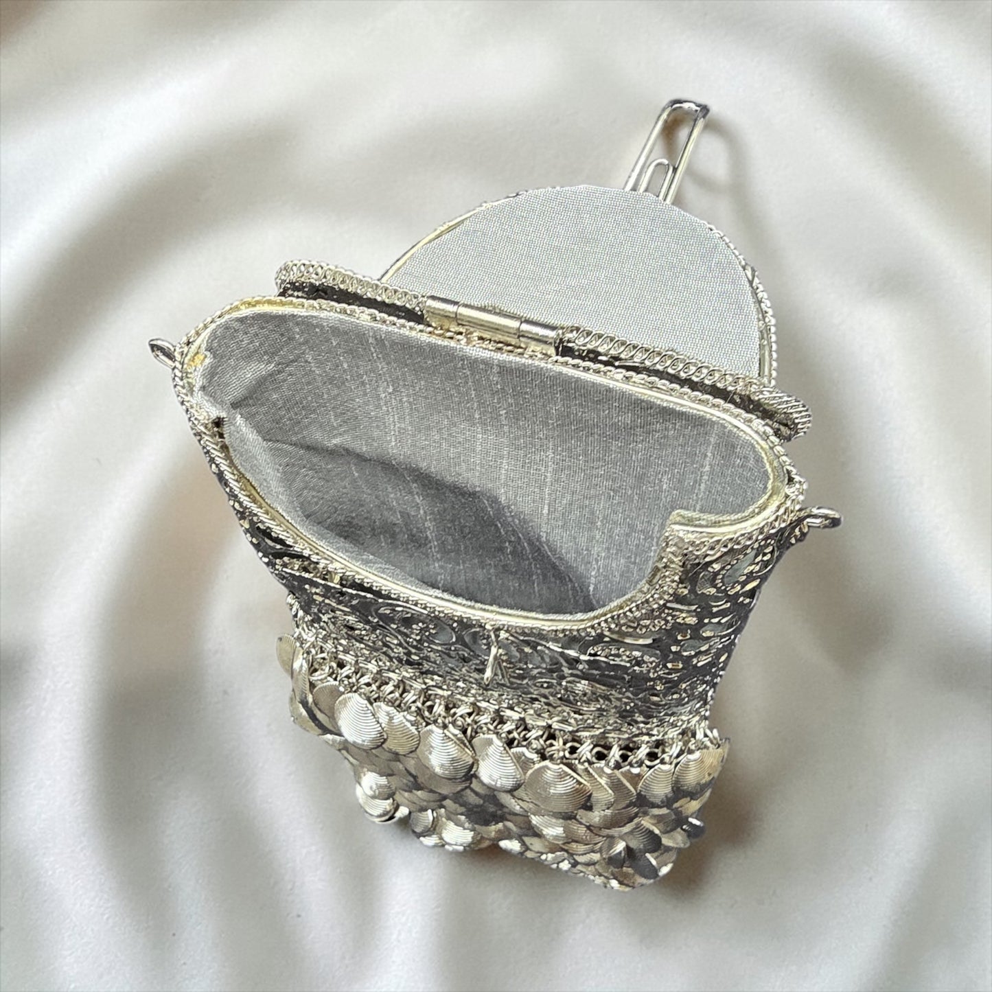 brass waist mobile clutch with danglers
gold metal wedding clutch with waist hook
designer Indian brass clutch bag
trending bridal mobile clutch silver