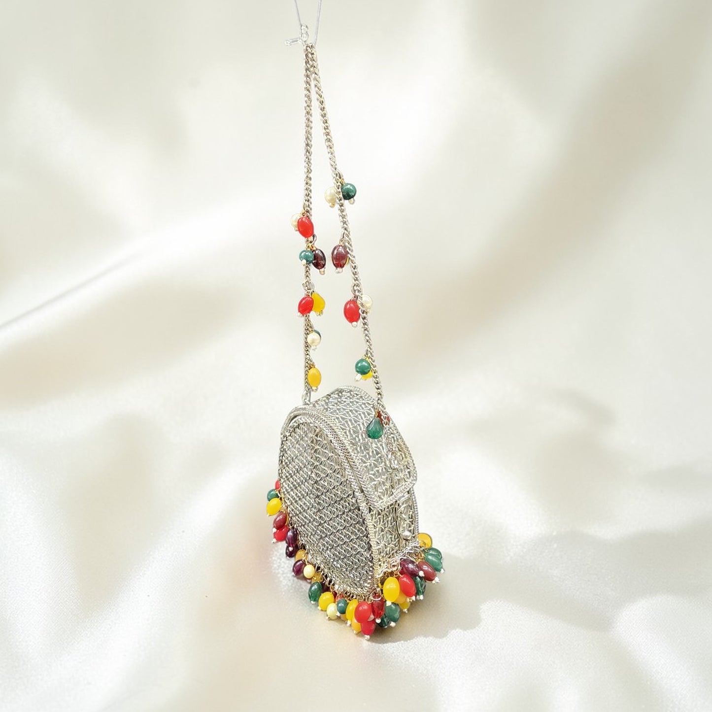 Unique drop silhouette brass handbag with vibrant bead fringe and silver-tone chain strap.