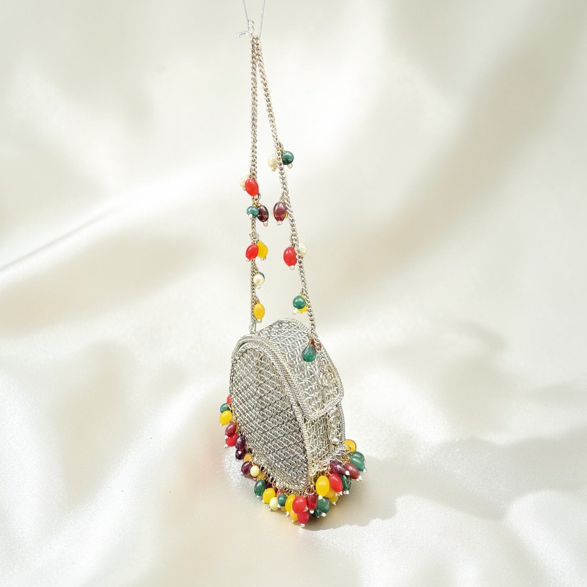 Unique drop silhouette brass handbag with vibrant bead fringe and silver-tone chain strap.