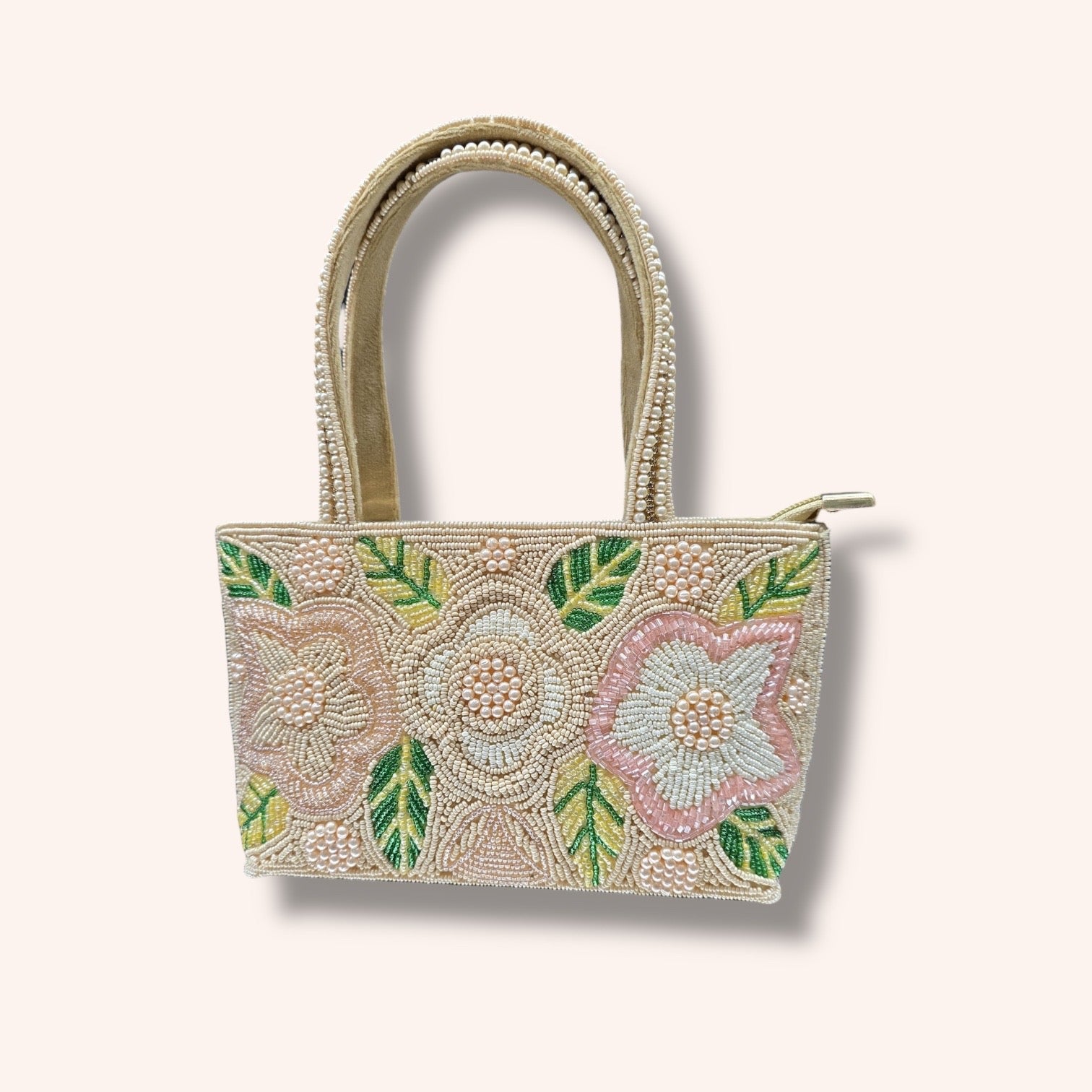 Hand-embroidered bucket bag with colorful floral beadwork and twin handles on a velvet base.