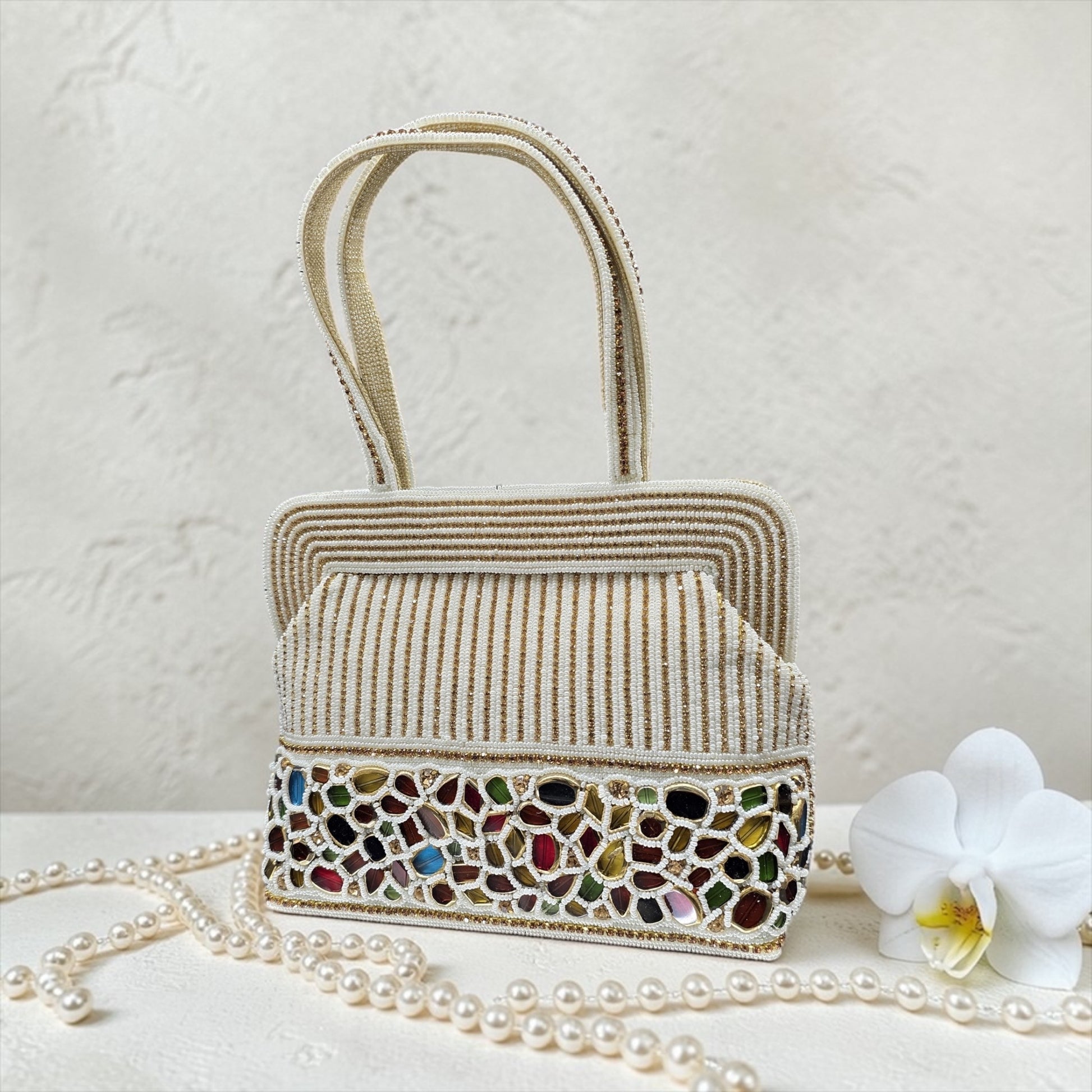 Hand-embroidered seed bead handbag with colorful stone border and twin embroidered handles.