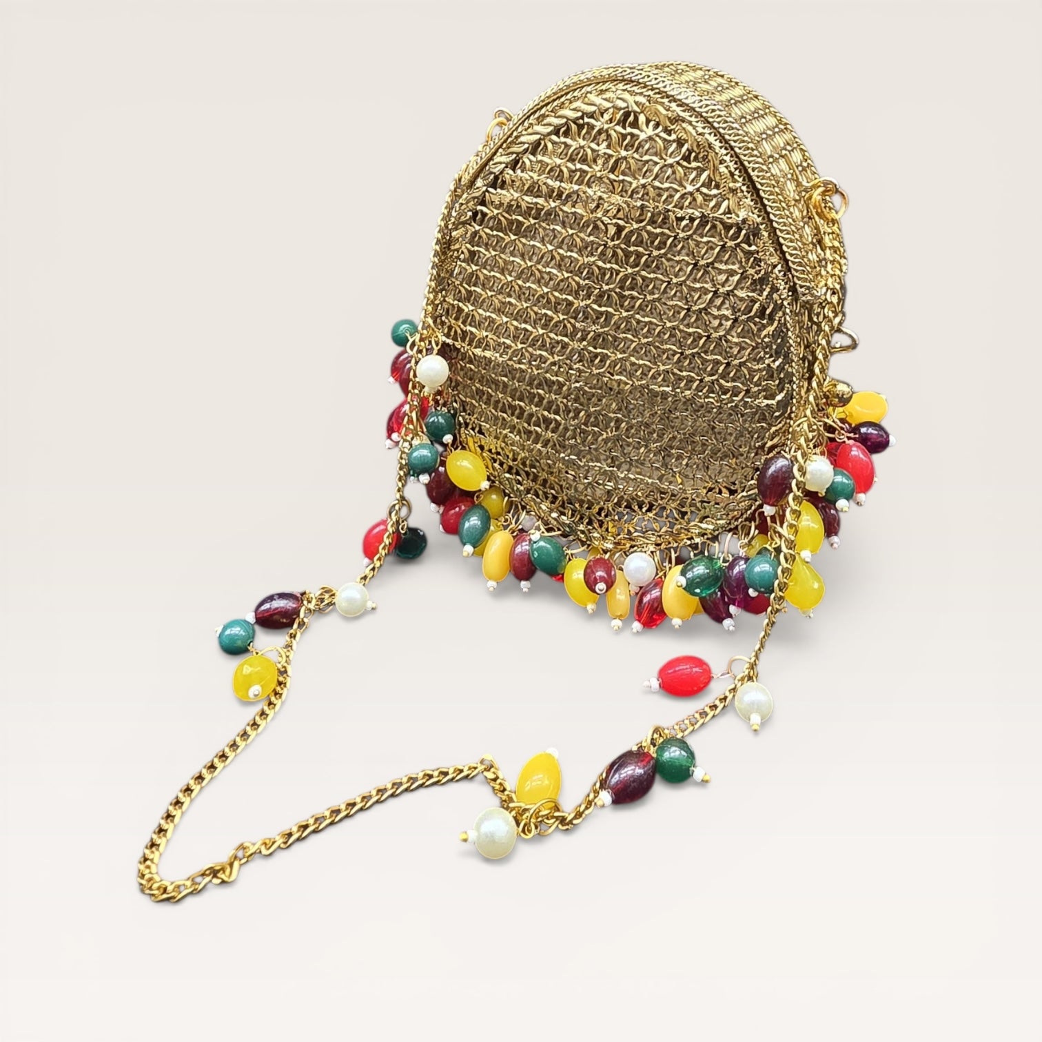 Unique drop silhouette brass handbag with vibrant bead fringe and gold-tone chain strap.