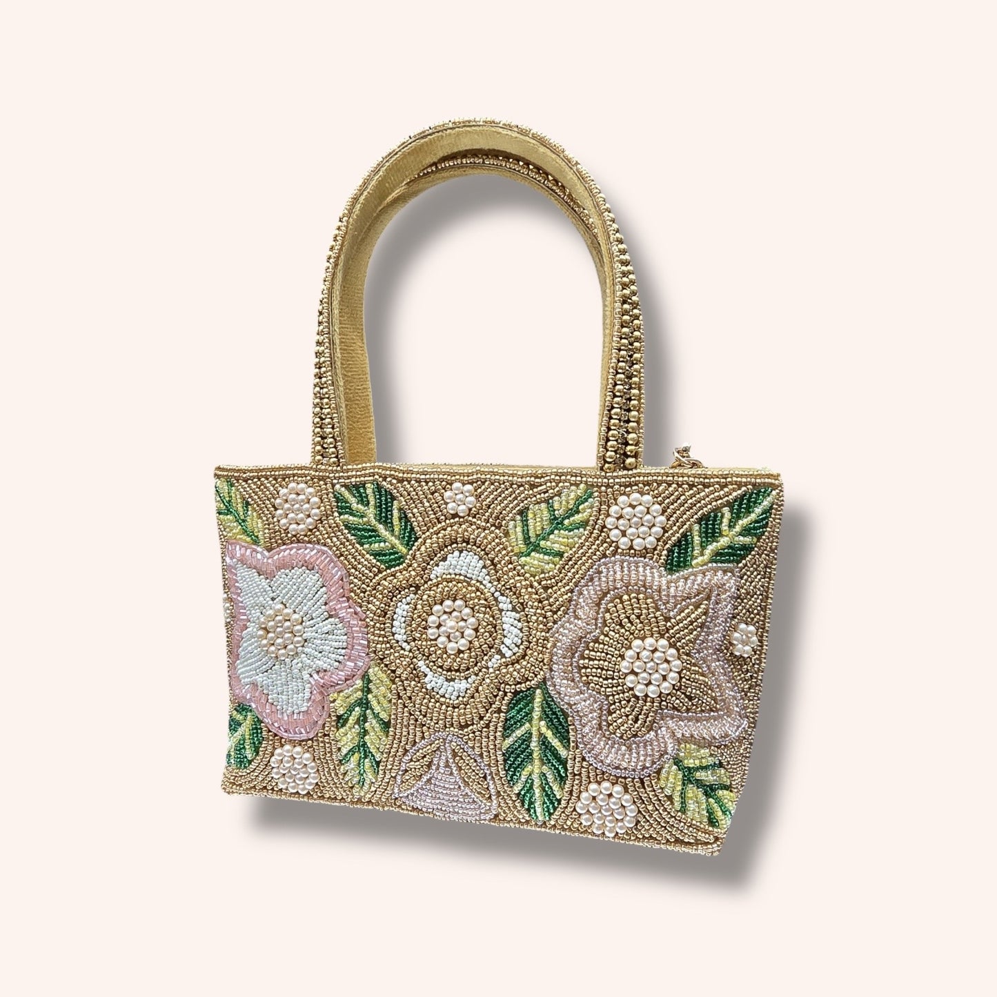 Hand-embroidered bucket bag with colorful floral beadwork and twin handles on a velvet base.