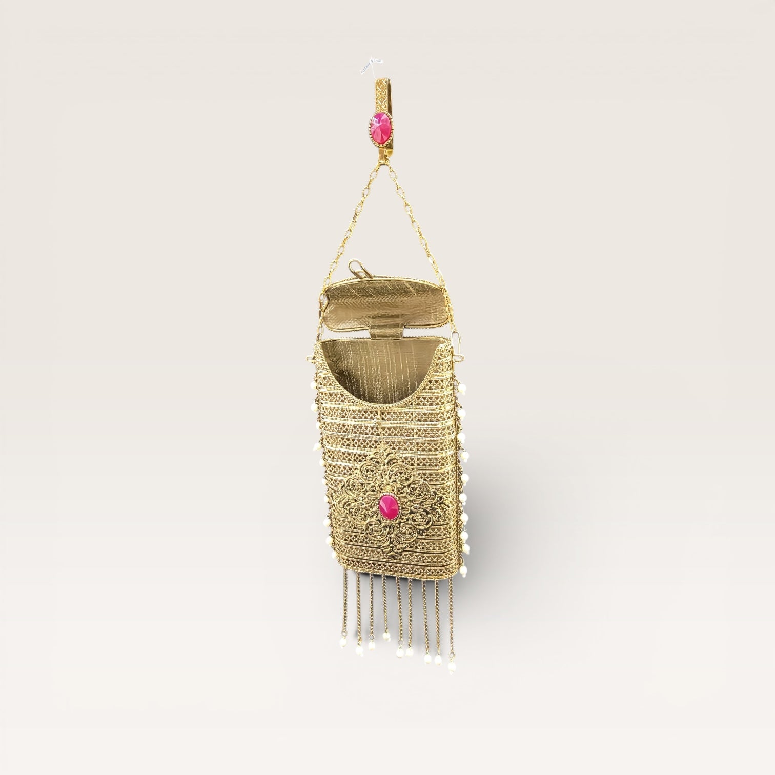 metal clutch with removable waist hook and chain handle
gold party clutch with tassels and pearl detailing