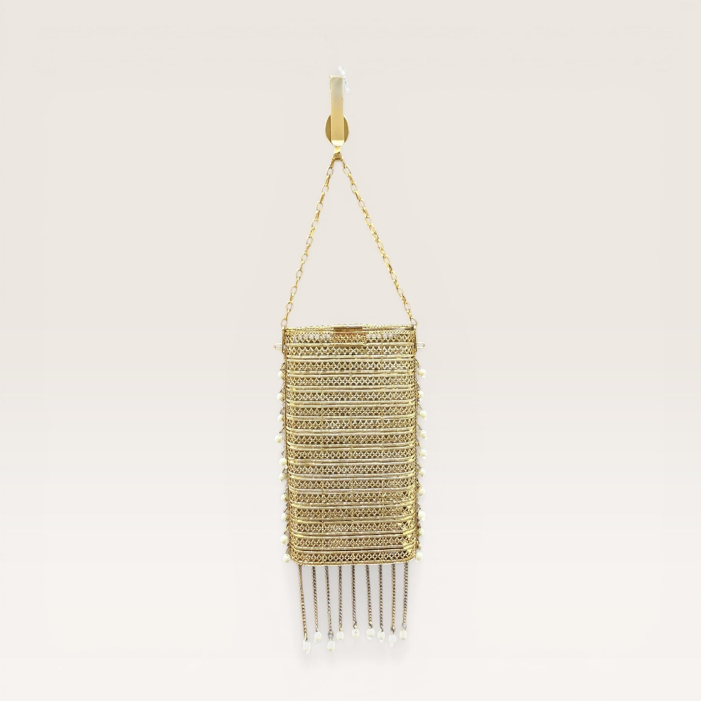 trending brass waist mobile clutch for women
Indian wedding gold clutch with tassel chains