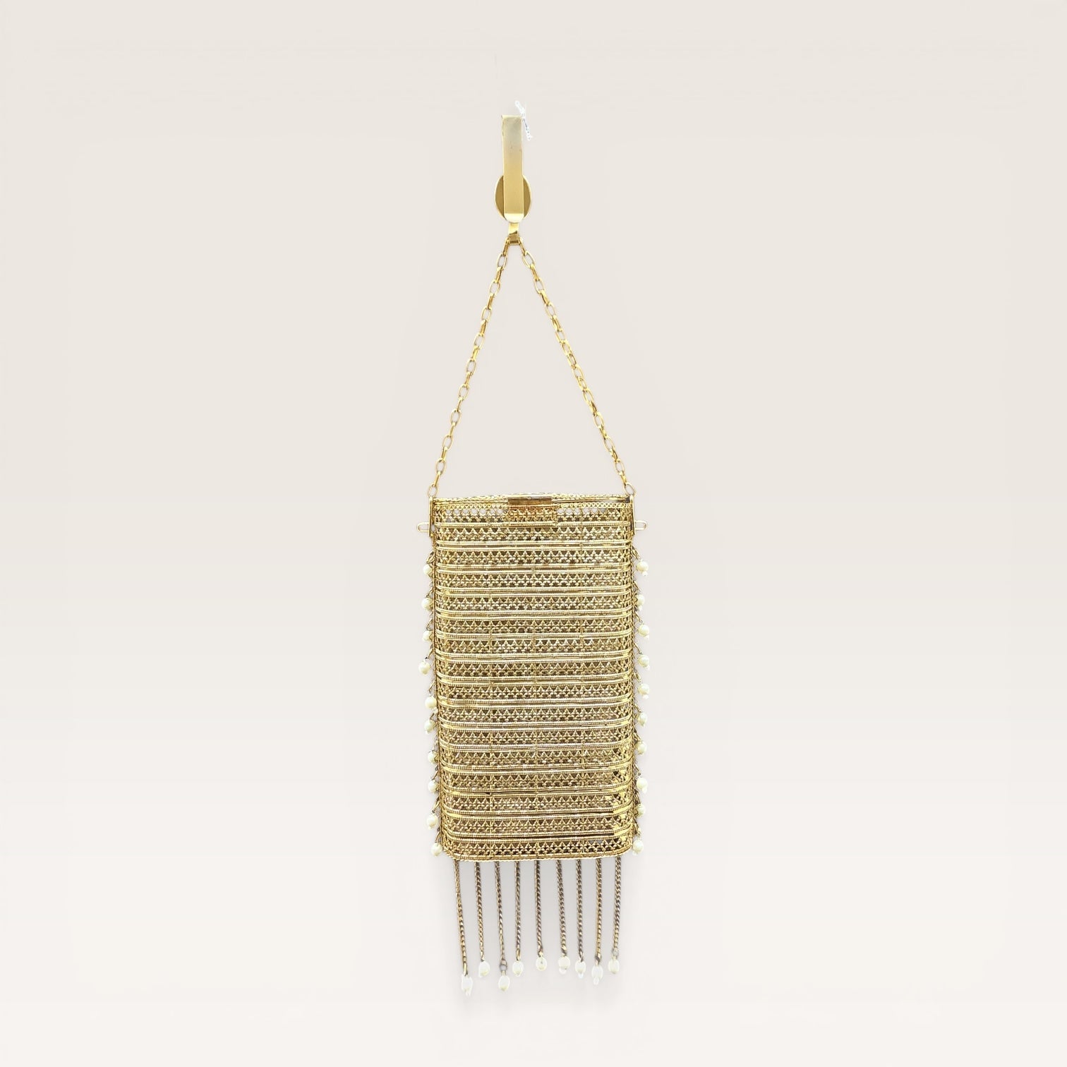 trending brass waist mobile clutch for women
Indian wedding gold clutch with tassel chains