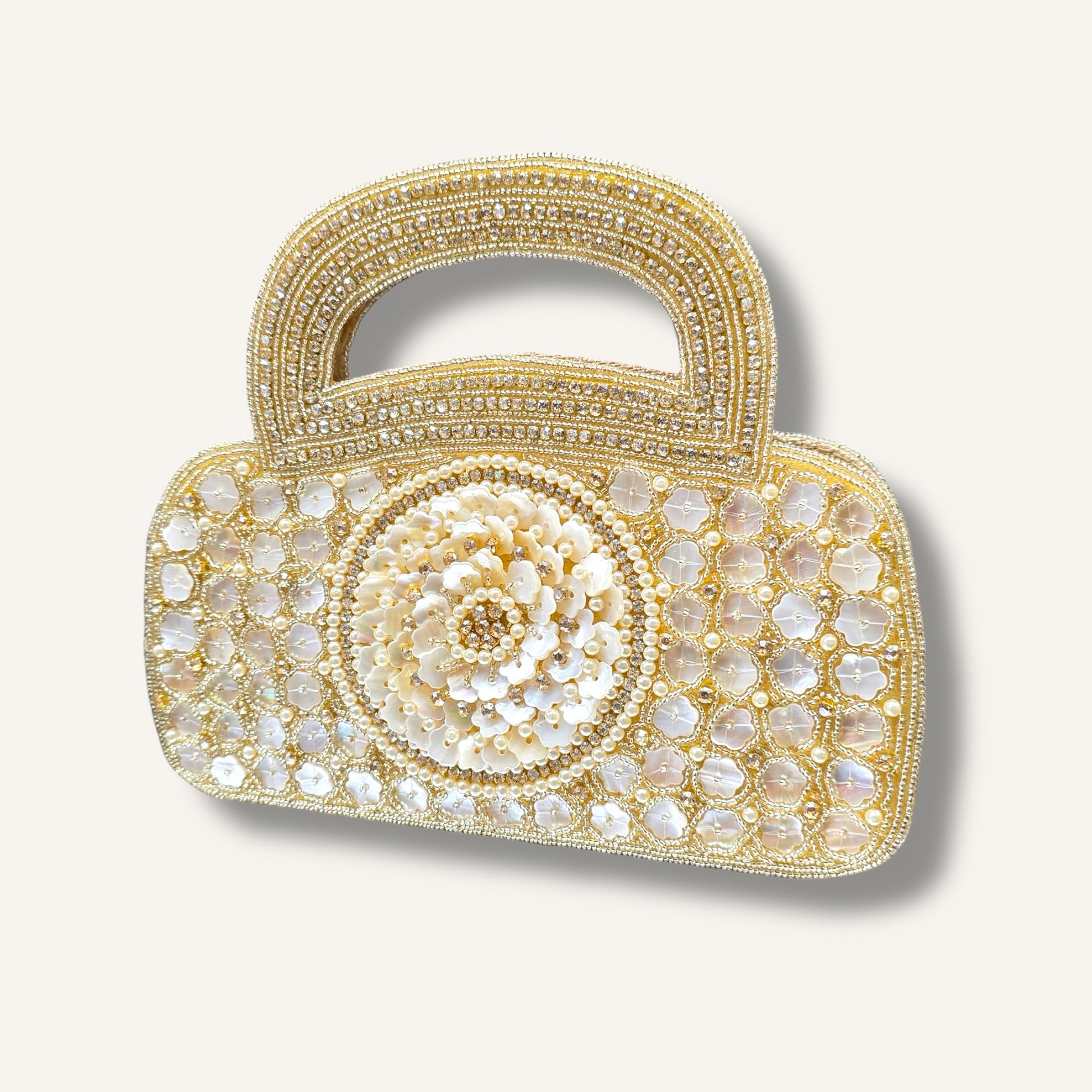 Dual-sided hand-embroidered luxury wedding bag featuring a central mother-of-pearl floral motif and a geometric pearl pattern on a natural jute base. This mini bucket-style bridal clutch includes a secure zip closure and an integrated hand-beaded handle, perfect for ethnic and festive wear
