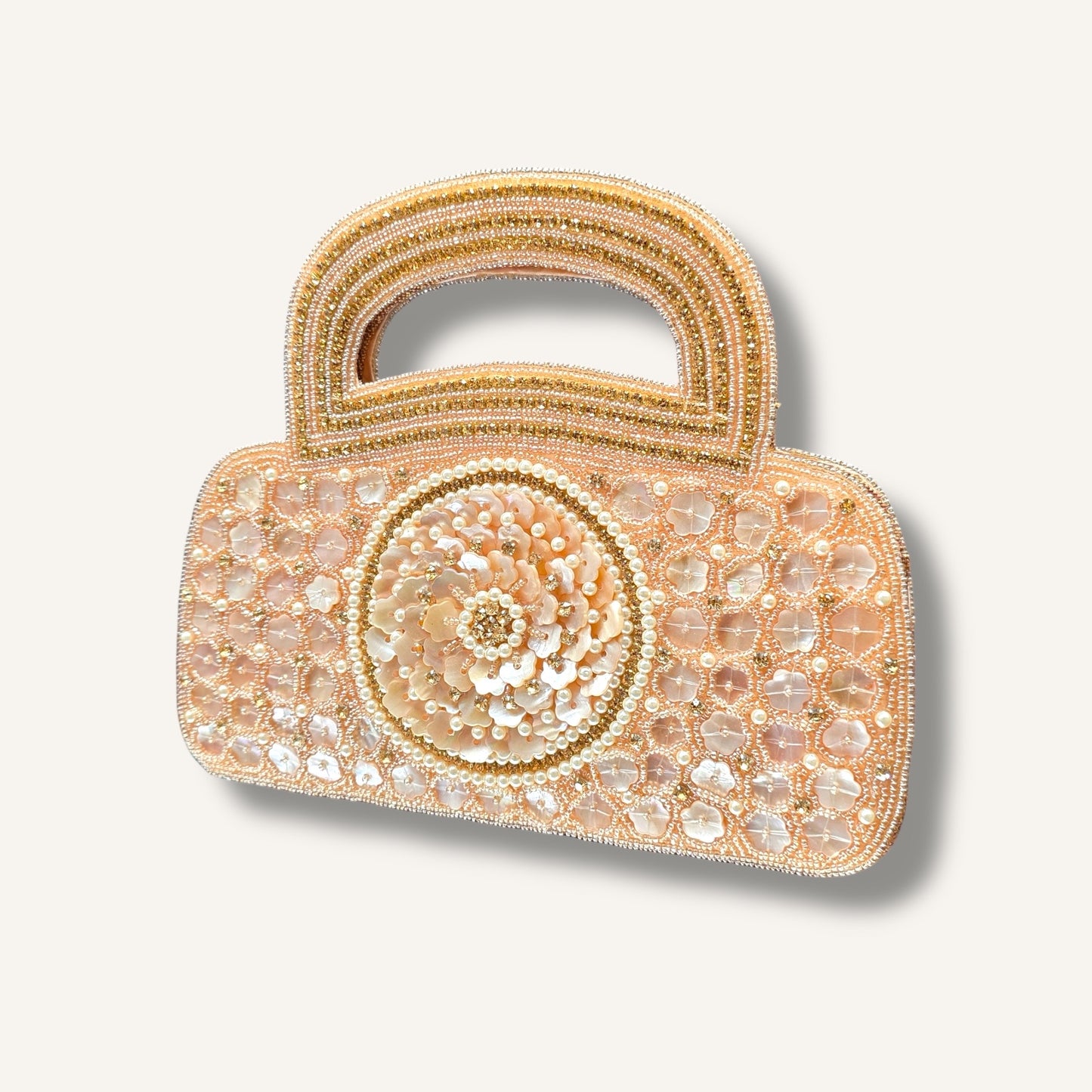 Dual-sided hand-embroidered luxury wedding bag featuring a central mother-of-pearl floral motif and a geometric pearl pattern on a natural jute base. This mini bucket-style bridal clutch includes a secure zip closure and an integrated hand-beaded handle, perfect for ethnic and festive wear