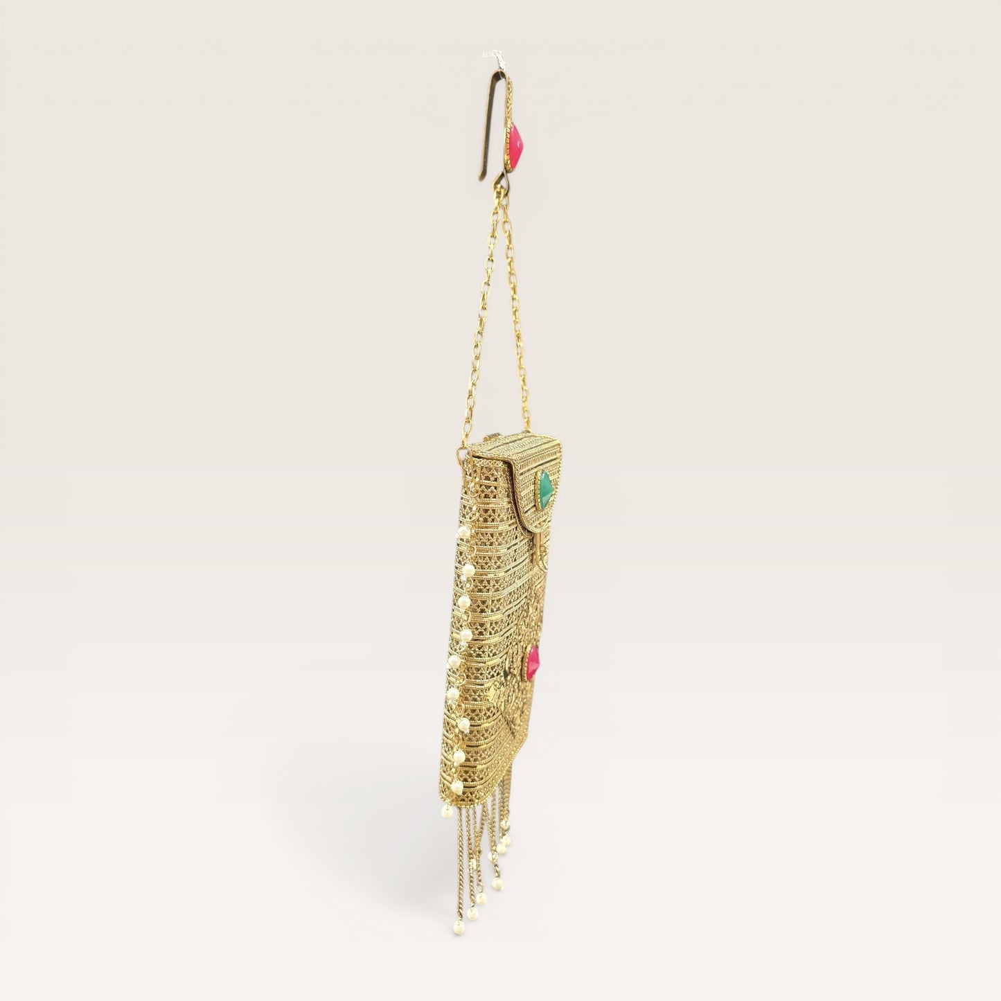 metal clutch with removable waist hook and chain handle
gold party clutch with tassels and pearl detailing