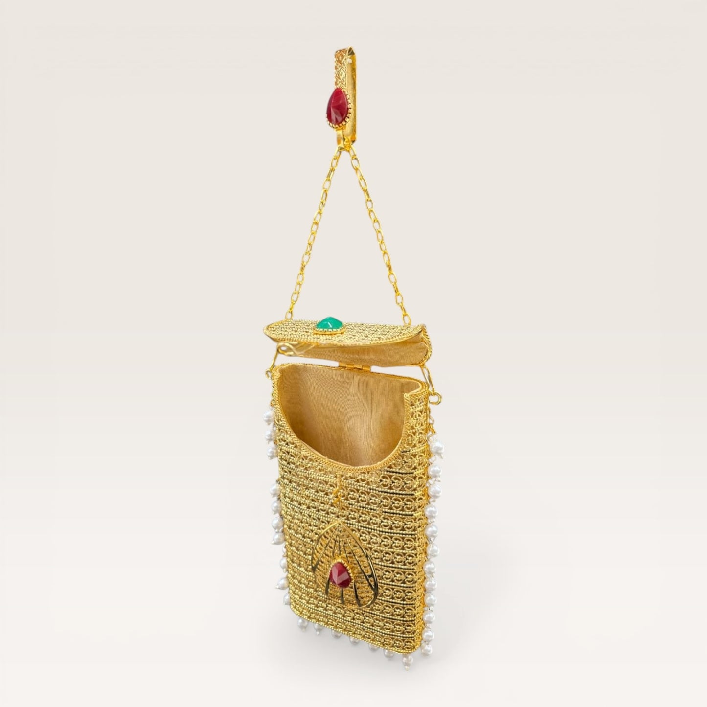 
Handcrafted brass clutch with pearl fringes and teardrop stone design, festive mobile pouch bag
Luxury brass mobile clutch with intricate detailing, pearl hangings and coloured stone embellishment
