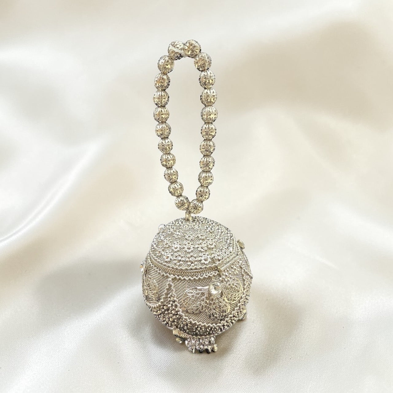 Aura kari Nariyal-Shaped Silver Mini Brass Clutch