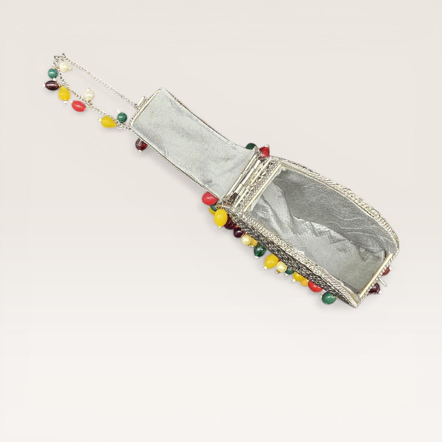 Handcrafted drop-shaped brass mini clutch with colorful hanging beads and fancy loop lock.