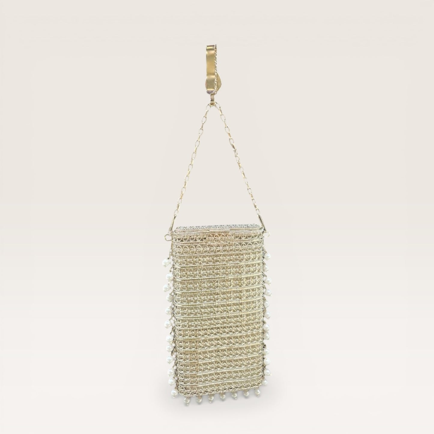 Ethnic brass mobile bag with pearl border detailing and gemstone accents, designer party clutch
Statement gold metal clutch with pearl hangings and teardrop stone motif, festive occasion bag