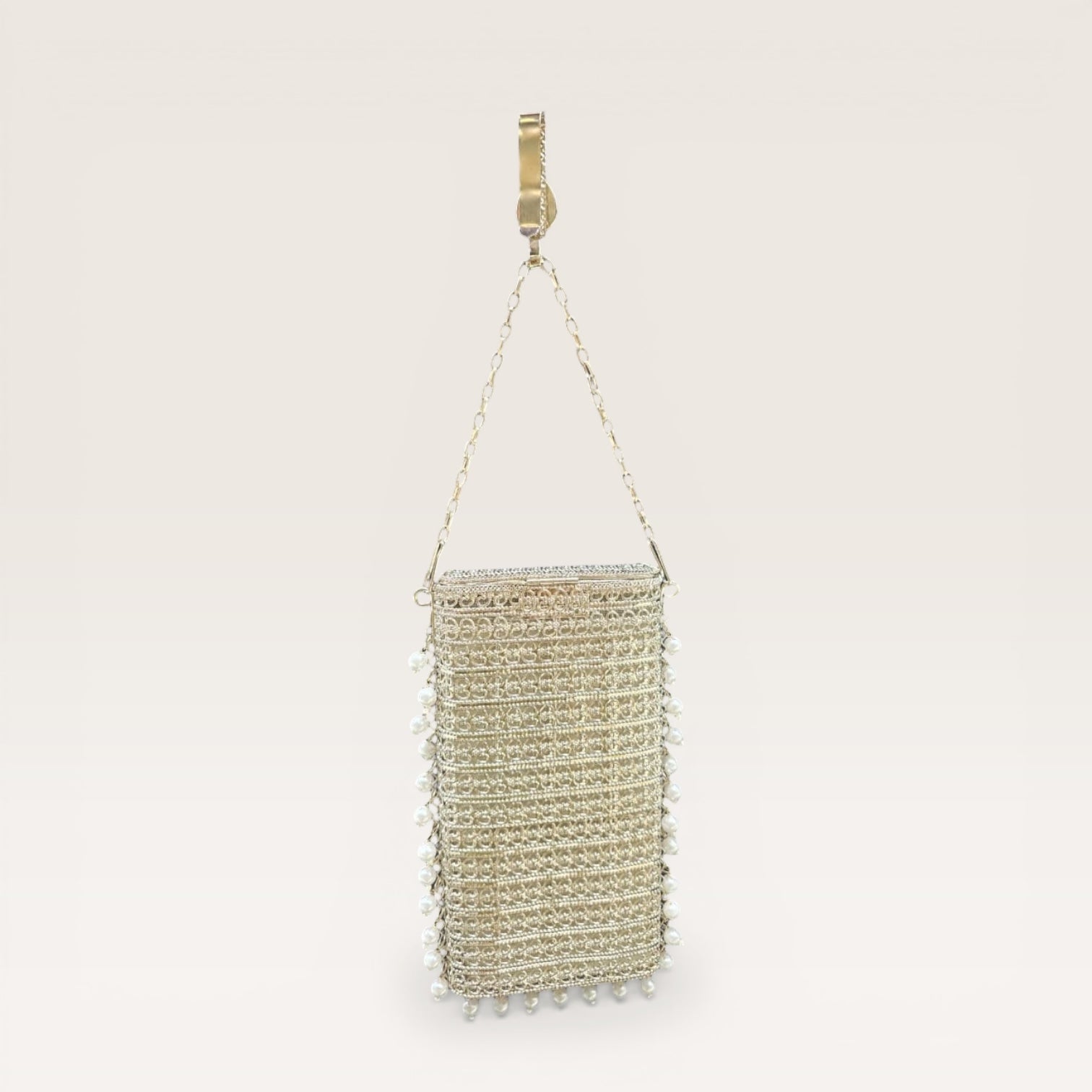 Ethnic brass mobile bag with pearl border detailing and gemstone accents, designer party clutch
Statement gold metal clutch with pearl hangings and teardrop stone motif, festive occasion bag