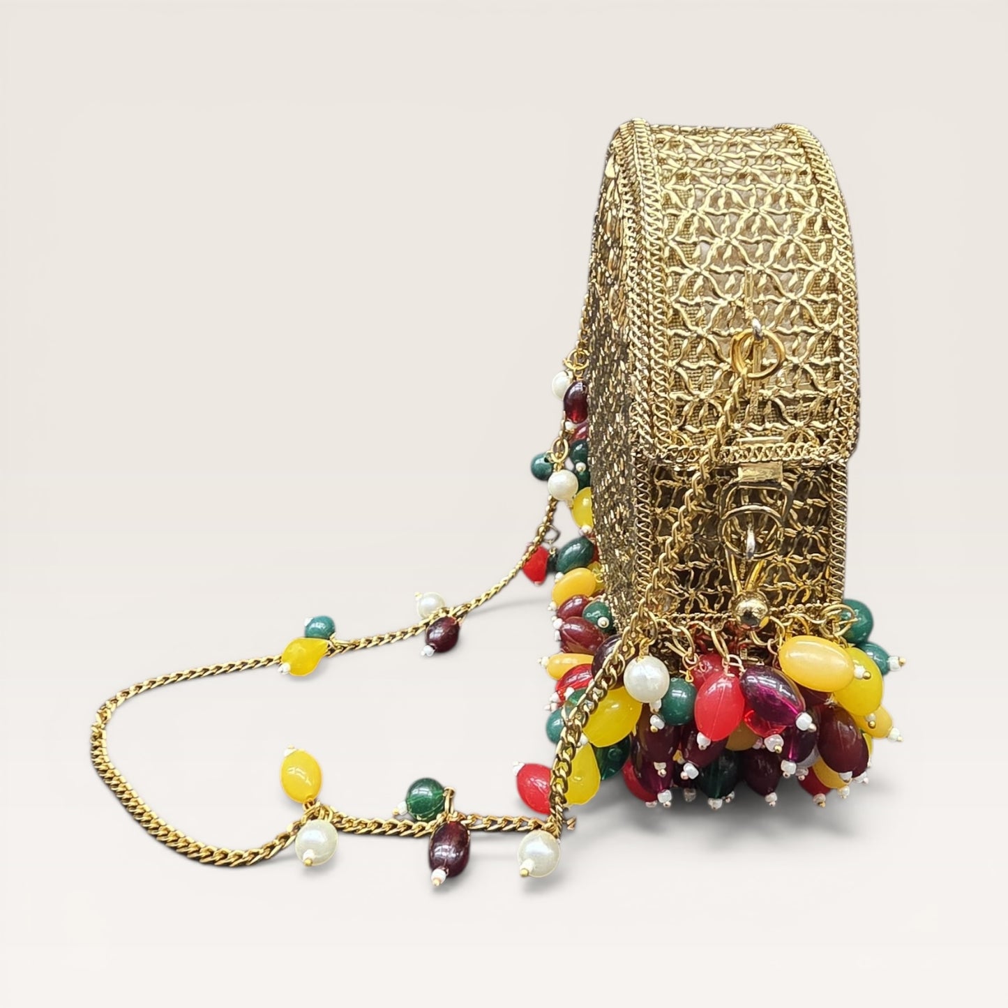 Brass metal party wear clutch with multi-color drop beads and chain handle for weddings.